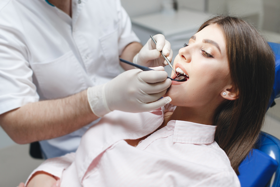 Bleaching of the teeth at dentist clinic. UV Whitening teeth. Repair  cracked or fractured teeth and remove teeth. Stock Photo